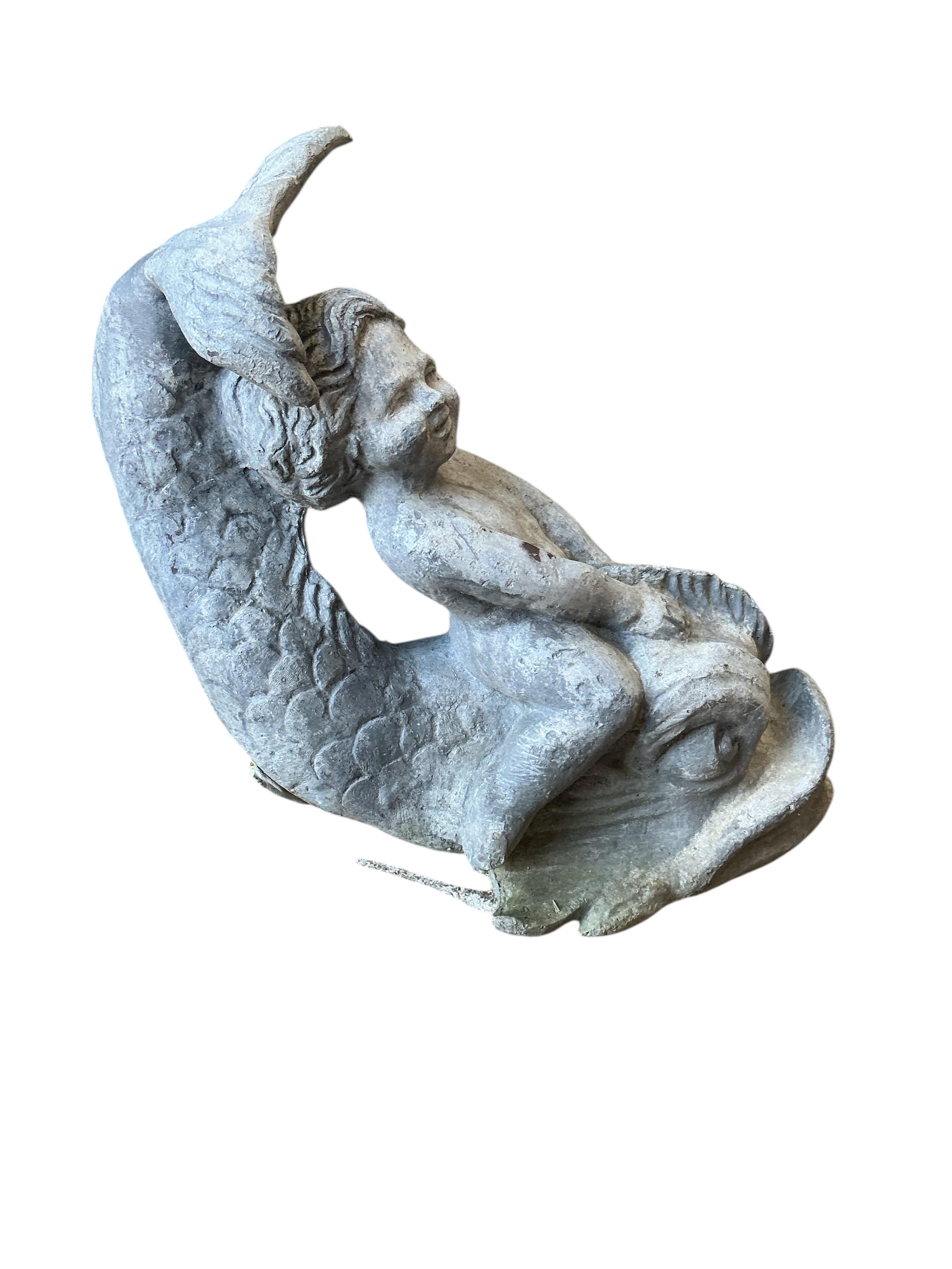 A 19th century lead putti riding a dolphin, height 30cm